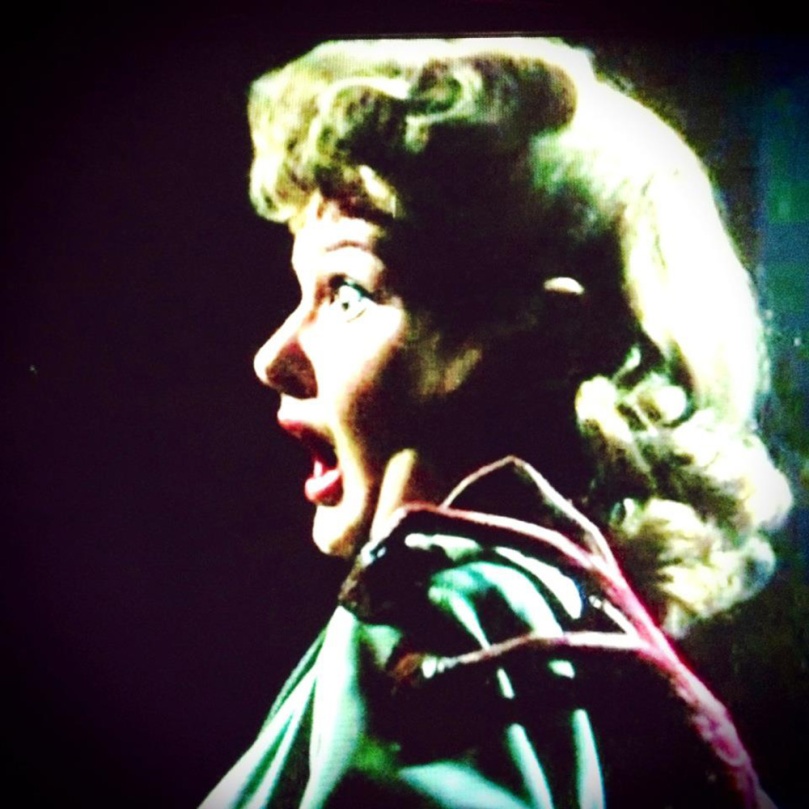 My crudely done frame grab from the 1953 War of the Worlds show thirtysomething girl-next-door Ann Robinson as Sylvia Van Buren with mouth agape as she feels an alien hand on her shoulder.