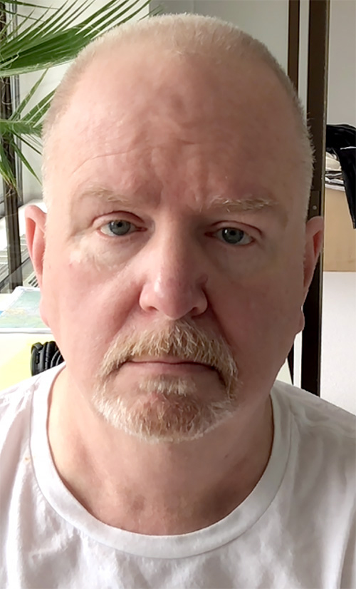 Selfie of me, Leigh Thomas Hanlon, staring into the camera with those wide-open puppy dog eyes.