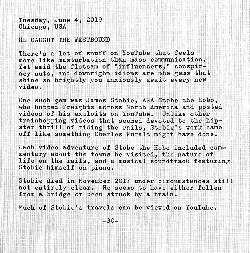 This photo of a typewritten document contains the following text. Tuesday, June 4, 2019 Chicago, USA. He caught the westbound. There's a lot of stuff on YouTube that feels more like masturbation than mass communication. Yet amid the flotsam of influencers, conspiracy nuts, and downright idiots are the gems that shine so brightly you anxiously await every new video. One such gem was James Stobie, AKA Stobe the Hobo, who hopped freights across North America and posted videos of his exploits on YouTube. Unlike other trainhopping videos that seemed devoted to the hipster thrill of riding the rails, Stobie’s work came off like something Charles Kuralt might have done. Each video adventure of Stobe the Hobo included commentary about the towns he visited, the nature of life on the rails, and a musical soundtrack featuring Stobie himself on piano. Stobie died in November 2017 under circumstances still not entirely clear. He seems to have either fallen from a bridge or been struck by a train. Much of Stobie’s travels can be viewed on YouTube.